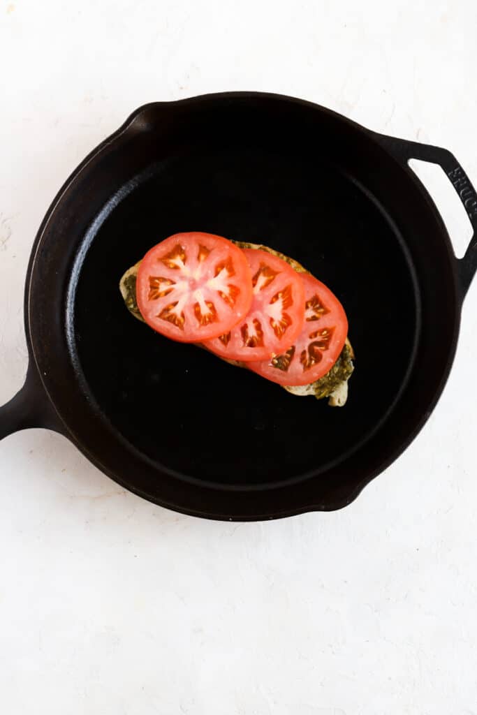 Add tomato slices on top of the pesto
