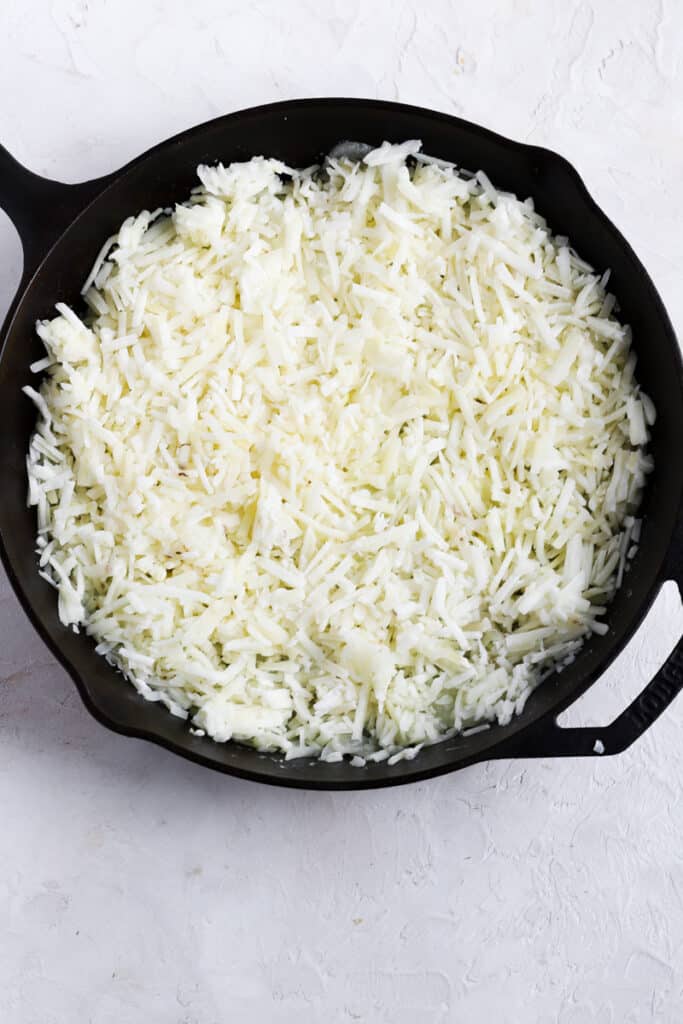 add hash browns to the cast iron pan